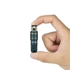 Hand holding a compact Olight USB-A charging connector, dark green with gold accents.