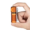 Olight Orange PERUN 2 MINI Headlamp Held by Hand for Everyday Carry and Outdoor Lighting