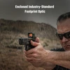 Man firing a pistol with an enclosed optic in the rain, highlighting its all-weather reliability and precision.