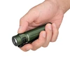 Hand holding an Olight compact green EDC flashlight with pocket clip against a white background