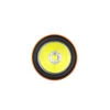 Close-up of a circular LED light, an orange and black trim frames the bright yellow light.