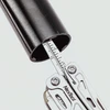 NexTool multitool ruler measuring the inner diameter of a black pipe on a white background