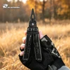 HX OUTDOORS black multi-tool pliers held by a gloved hand in a grassy field