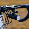Garmin bike computer and front light mounted on bicycle handlebars.