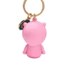 Pink cartoon figure keychain, back view, with gold ring and small blue charm.