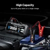 Topdon V3000 high capacity jump starter with heavy-duty clamps connected to a car battery for emergency power backup