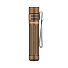 Warrior Mini 3 tactical flashlight in bronze with textured grip and black clip.