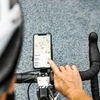 Cyclist navigates using a smartphone bike mount displaying a map with nearby restaurants.
