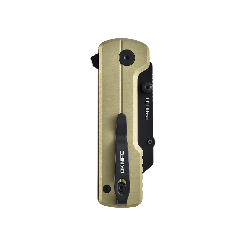 Closed gold Oknife U1 Ultra pocket knife with black pocket clip isolated on black background