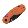 Closed orange pocket knife with a carved pumpkin face design, purple accents, and a black blade on a white background.