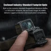 Hand adjusts Osight XE AMRS optic in rain, highlighting rugged protection and pistol compatibility.