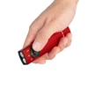 Hand holding a red Olight Arkfeld flat EDC flashlight with white light, laser, and UV selectors on white background