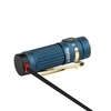 Olight Blue Baton 4 rechargeable flashlight side view, charging with textured grip and gold pocket clip for everyday carry.