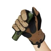 Hand in tactical gloves holding a green military flashlight.