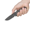 Olight Rubato 4 black folding knife held in hand, showing textured G10 handle for everyday carry and utility.