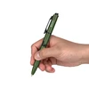 Hand holding an Olight OD green tactical pen with an integrated flashlight.