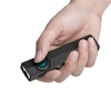 Olight Black ArkPro Lite flashlight held in hand, pressing the turquoise button for everyday carry and general illumination.
