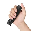 Hand holding a sleek black Olight flat flashlight showcasing its compact size and ergonomic design for daily carry