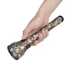 Olight Javelot Turbo 2 digital camouflage long-range flashlight held in hand, showing side switch and battery indicator for tactical use