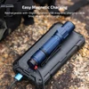 Blue Olight flashlight charging magnetically on a portable solar panel, outdoors.
