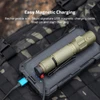 Olight tactical flashlight charging with USB magnetic cable on portable power bank outdoor gear background
