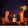 Halloween themed Olight flashlights and pocket knife displayed with pumpkins and spooky castle background