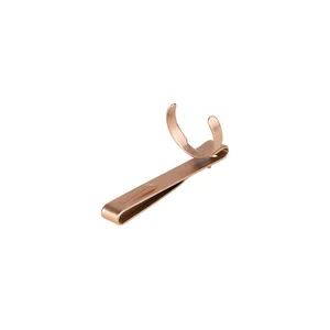 Copper-colored metal clip with a U-shaped pen or tool holder, sleek design, office supplies or handyman's accessory