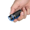 Olight Black and Blue Baton 4 Premium Flashlight held in hand, side view with textured grip and blue pocket clip for EDC.