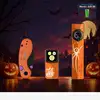Halloween edition orange EDC flashlights and pocket knife displayed with pumpkins and spooky castle background