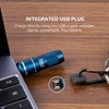 Olight Blue imini 2 Keychain Light plugged into a laptop for USB charging, showing its integrated USB plug.