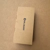 Olight PL-3R weapon light, top view of brown cardboard packaging for tactical use