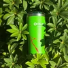 Green Olight stainless steel tumbler nestled in lush green leaves under bright sunlight