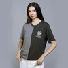 Woman in a two-tone t-shirt, gray and black, with a circular logo and text "Rethink Light. Reimagine Style."