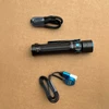 Olight Black Warrior Mini 2 Tactical Flashlight Top View with Charging Cable and Accessories for Everyday Carry