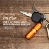 Olight Orange i1R 2 Pro Keychain Light on wood table with car keys, 180 lumens USB-C rechargeable for EDC.