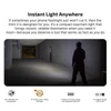 Person illuminates a dark hallway with a compact imini 2 keychain flashlight, providing instant, reliable light.