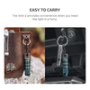 Imini 2 portable flashlight on a keychain, attached to a leather pouch and car keys, for convenient, quick access.