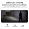 Man with imini 2 compact keychain light illuminates a dark, empty passage, showing instant, reliable light.