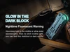NexTool glow in the dark multitool resting on wood logs at night