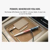 USB-C charged stylus pen with US flag design in car compartment, next to leather tag.