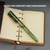 Green multi-tool pen, 6.10 inches long, resting on an open journal, showcasing its textured grip and integrated features.