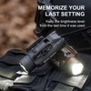 Two Olight Valkyrie PL-3 R weapon lights, black and brown, with memory function on tactical gear