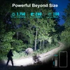 Hiker using powerful compact flashlight on dark forest path, featuring 1750 lumens, 240m throw, and 100-day runtime.