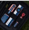 Olight USA Flag Theme ArkPro Flashlight and EDC Gear Organized in a Black Pouch for Outdoor Tactical Use
