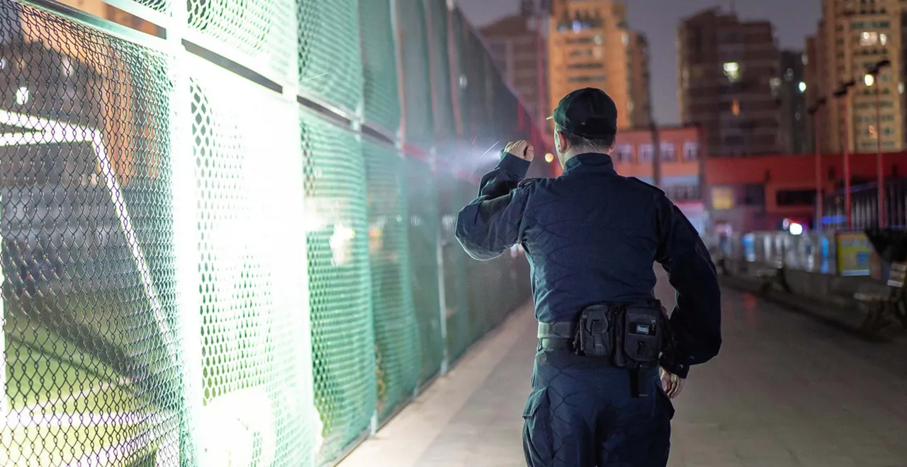 Security guards patrol the playground with flashlights.
