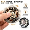 Hand spinning a metal EDC fidget spinner with gold waves and bronze beads, showcasing pocket size and one-hand ease of use