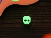 Glow in the dark green skull bead on a dark wooden background for Halloween crafts