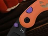 Halloween themed folding pocket knife with orange handle purple accents and trick or treat engraved black blade